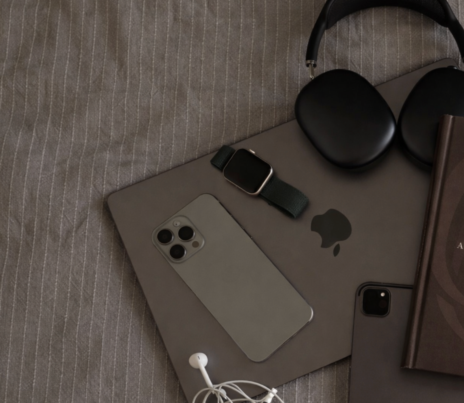 Phone, watch, headphones, and book titled 'Character Over Chemistry' on a textured surface